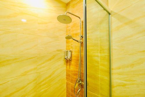 a shower with a glass door in a bathroom at Family Holiday Fun APT Netflix by MESA in Nagoya