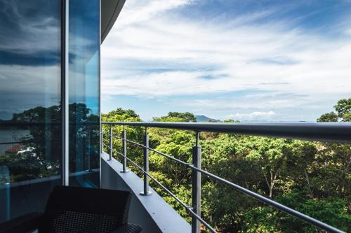 a balcony with a view of the forest at Oceanview Apt Near Panama City w/ King Bed & More in Playa Bonita Village