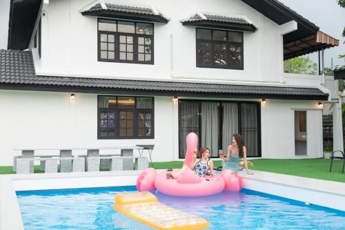 two girls playing in the pool in a house at Number3 Poolvilla Bangkok in Lat Krabang