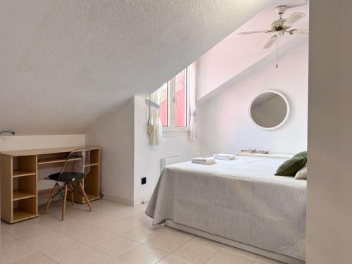 a bedroom with a bed and a desk and a window at El Solsticio - 30601 in Somo