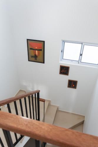 a room with stairs and a picture on the wall at O Sobrado Mariazinha & Inácio Lima in Praia