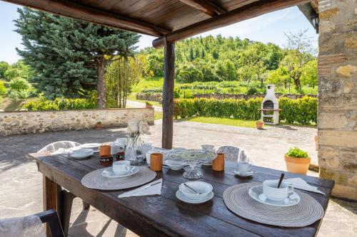 a wooden table with plates of food on it at Podere Marcigliana in Radicondoli