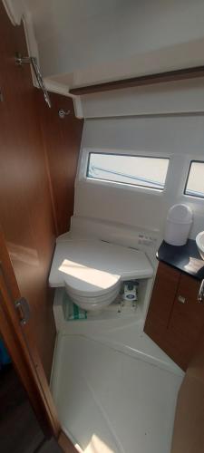 a small bathroom with a toilet in a boat at Parenthèse au lac in Aix-les-Bains