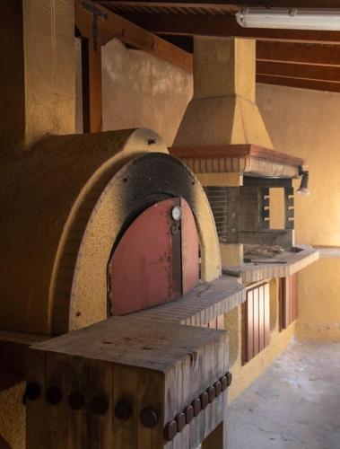 a large brick oven in a kitchen with at Nerotrivia stone house in Nerotriviá