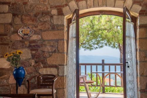 an open door to a patio with a view at Nerotrivia stone house in Nerotriviá