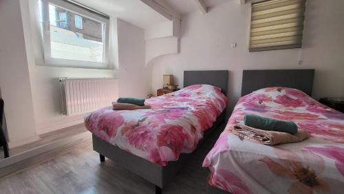 two beds sitting next to each other in a bedroom at BnB Souterrain in Amsterdam