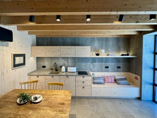 a kitchen with a counter and a table with chairs at Casa da Eira, Casaspensadas in Juncal