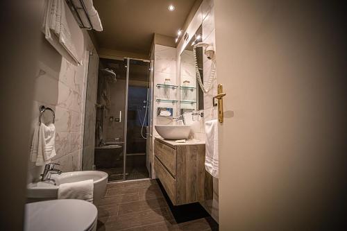 a bathroom with a sink and a toilet and a shower at Hotel Ca' D'Oro Tre Stelle Superior Adults only in Bibione