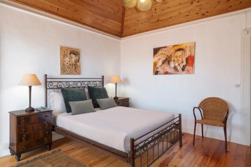 a bedroom with a bed and a wooden ceiling at Quinta da Fonte by An Island Apart in Calheta