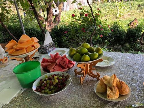 a table with plates of fruit and vegetables on it at Lori Hills Agritourism in Gyulagarak