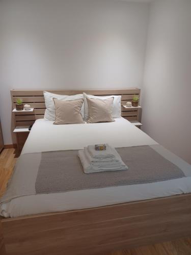 a bedroom with a bed with a towel on it at Natura House in Aveiro
