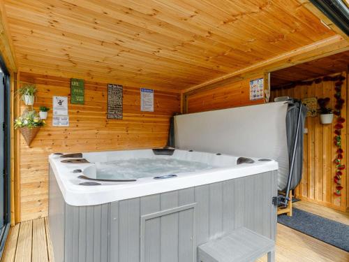 a hot tub in a room with a wooden ceiling at 5 Bed in Falmouth 65745 in Gwennap