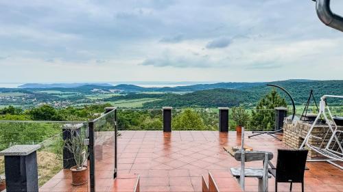 a balcony with a view of the mountains at Borospince Vendégház in Pécsely