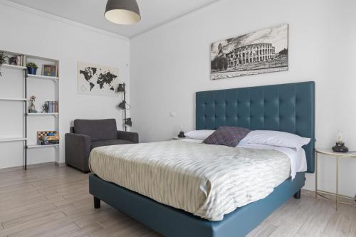a bedroom with a blue bed and a chair at SAPIENZA Apartment in Rome