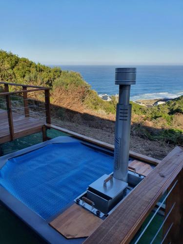 a plunge pool on a deck with the ocean in the background at Dolly@Skuitbaai in Eersterivierstrand