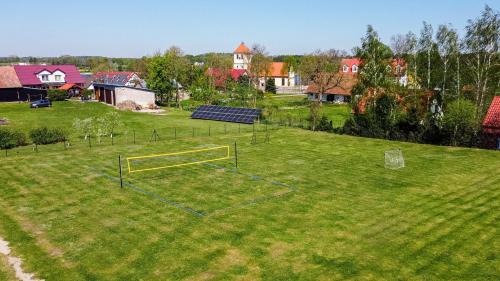 an aerial view of a field with a soccer goal at Domki przy Akacjowej in Rydzewo