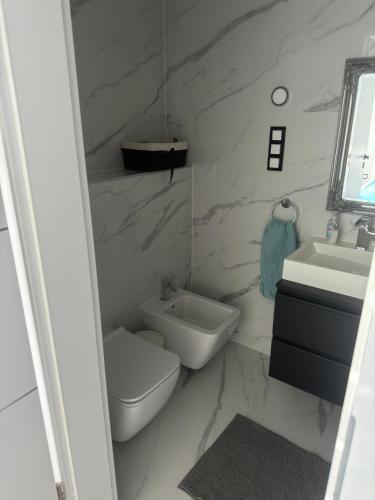 a bathroom with a toilet and a sink at Belle Casa Villa in Debrecen