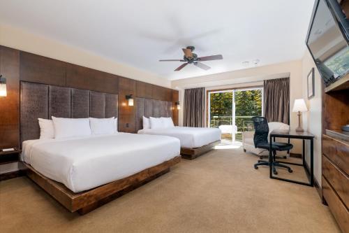 a hotel room with two beds and a television at The Peaks Resort and Spa in Telluride