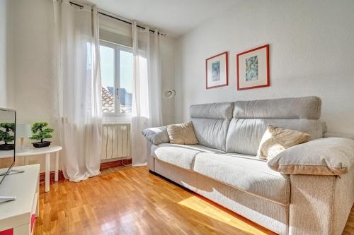 a living room with a couch and a window at Mesón Pamplona by Clabao in Pamplona