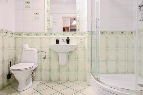 a bathroom with a toilet and a sink and a shower at D&A Apartments Szewska in Krakow