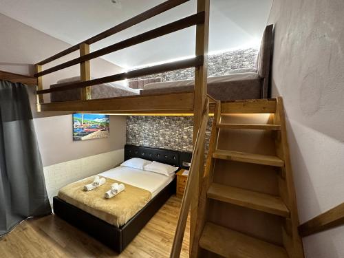 a small room with a bunk bed and a staircase at Anel Studios in Vlorë