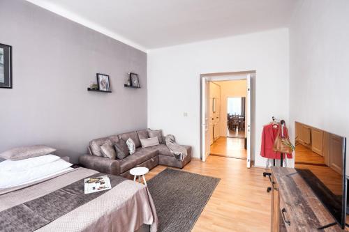 a living room with a bed and a couch at Prague - Karlin Apartments in Prague