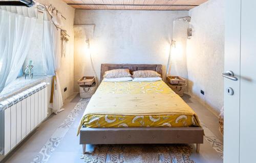 a bedroom with a bed and two night stands at 3 Bedroom Awesome Home In Filignano in Filignano