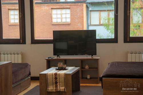 a living room with a flat screen tv on a table at Departamentos - Belgrano 810 in San Martín de los Andes