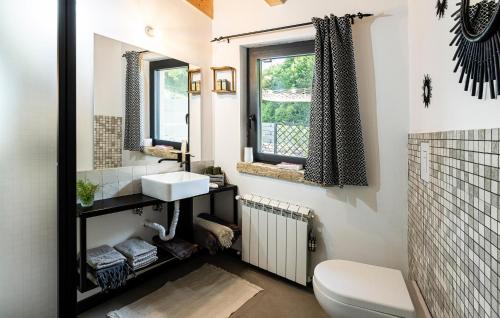 a bathroom with a toilet and a sink and a window at 3 Bedroom Awesome Home In Filignano in Filignano
