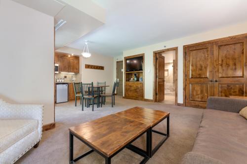 a living room with a couch and a coffee table at The Peaks Resort and Spa in Telluride