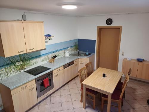 a kitchen with a wooden table and a table and a table and chairs at Wohnung in Medlitz in Rattelsdorf