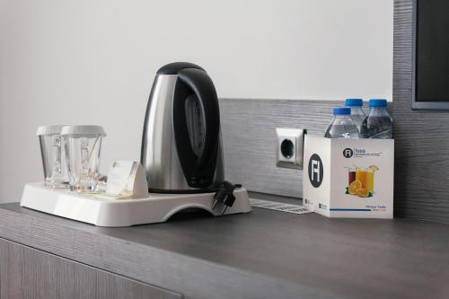 a kitchen counter with a blender and a box of water at Fesa Business Hotel in Gebze