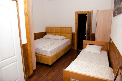 a small room with two beds and a doorway at Etno selo Bok in Vrhpolje
