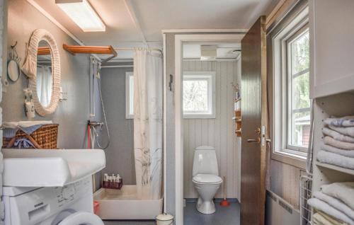 a bathroom with a white toilet and a sink at Lovely Home In Kallinge in Kallinge