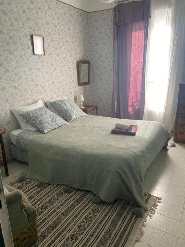 une chambre avec un grand lit et une fenêtre dans l'établissement Maison centre ville, belle décoration, à Sète