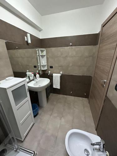 a bathroom with a sink and a toilet and a mirror at San Lorenzo casa vacanza in Campi Salentina