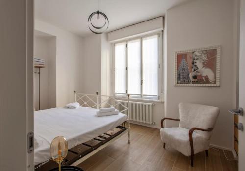 a bedroom with a bed and a chair and a window at -Art Gallery- Luxury Boutique in center of Como in Como