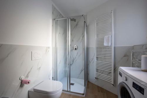 a white bathroom with a shower and a toilet at -Art Gallery- Luxury Boutique in center of Como in Como