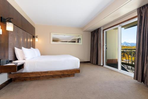 a bedroom with a bed and a large window at The Peaks Resort and Spa in Telluride