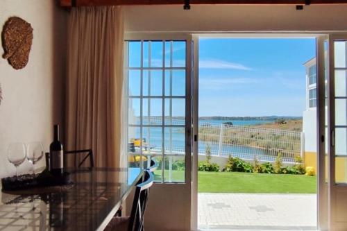 a kitchen with a view of the ocean at A Nossa Estrela nº7 in Póvoa de São Miguel