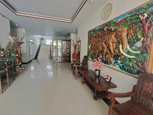 a hallway with a large painting on the wall at The Rich Room ห้องพักโคราช in Ban Pra Dok