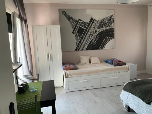 1 dormitorio con 1 cama y una foto de la torre Eiffel en Al 97 Locazione turistica, en Romano D'Ezzelino