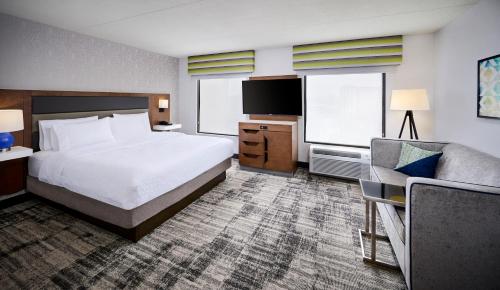 a hotel room with a bed and a couch at Hampton Inn & Suites by Hilton Windsor in Windsor