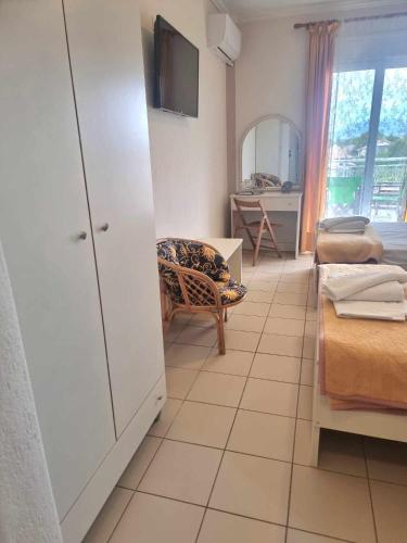 a room with a bedroom with a couch and a table at Hotel Nautilos in Sozopoli