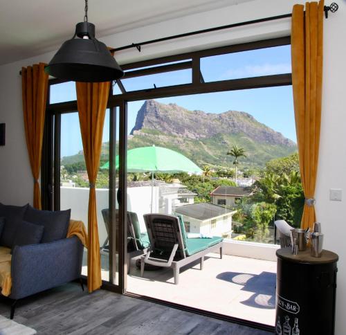 a living room with a view of a mountain at Lux Penthouse Apartment 3 bedrooms Quatre Bornes in Quatre Bornes