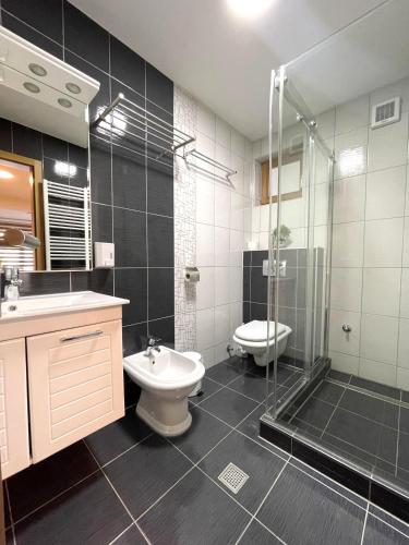 a bathroom with a shower and a toilet and a sink at Villa Sarajevo in Vareš