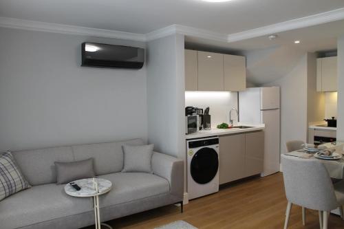 a living room with a couch and a kitchen at Garlon Residence in Istanbul