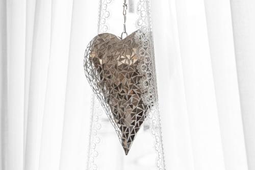 a heart shaped object hanging from a chain at Hotel Baer & Post Zernez in Zernez