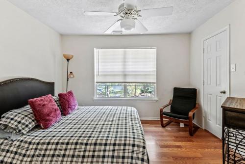 a bedroom with a bed with purple pillows and a ceiling fan at Amazing house in Woodlands fully equipped for 6 in Conroe