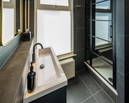 a bathroom with a sink and a window at Square Boutique Hotel & Brasserie in Venray